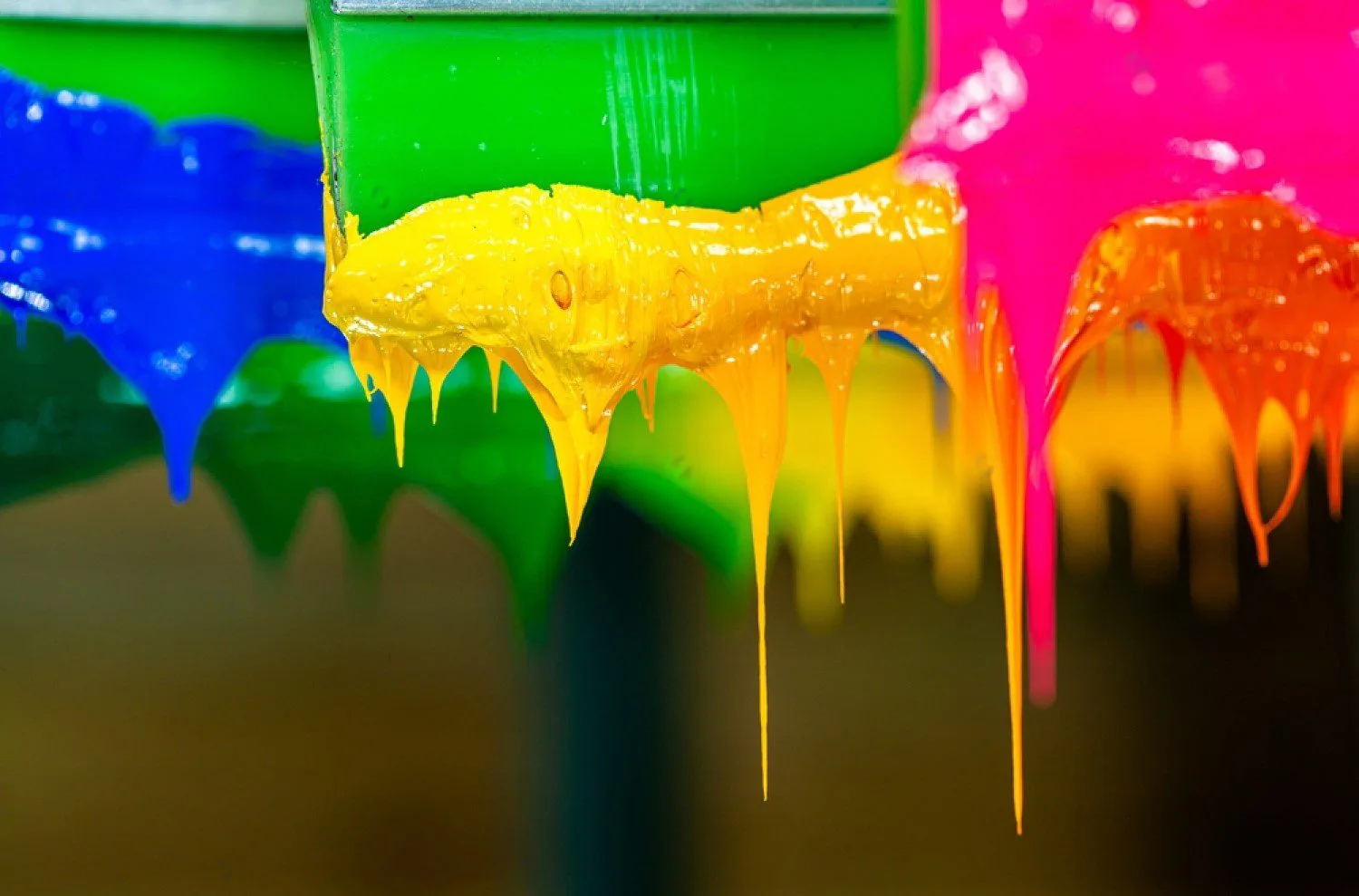 Colored inks ready on a silk screen printer in a t-shirt factory